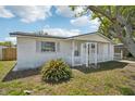 Inviting single-story home featuring a charming front porch and well-maintained landscaping at 7034 N King Arthur E Dr # 4, Port Richey, FL 34668