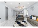 Bright living room features tile floors, ceiling fan, and modern decor accents at 8312 40Th N St, Pinellas Park, FL 33781
