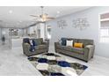 Bright living room features tile floors, ceiling fan, and modern decor accents at 8312 40Th N St, Pinellas Park, FL 33781