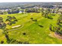Gorgeous aerial view of lush green golf course with mature trees, ponds, and manicured landscaping at 11050 Kiskadee Cir, New Port Richey, FL 34654