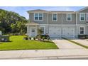 Inviting townhome with lush lawn, garden, and convenient one-car garage at 12214 Grizzly Ln, New Port Richey, FL 34654