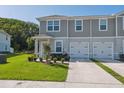 Attractive townhome with a one-car garage, manicured lawn, and fresh landscaping at 12214 Grizzly Ln, New Port Richey, FL 34654