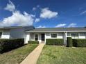 Attractive single-story residence featuring lush green lawn and manicured shrubbery at the front entrance at 12541 Dearborn Dr # B, Hudson, FL 34667