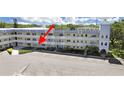 Exterior of a condo building with ample parking, well maintained lawns, and second story balconies at 2221 Swedish Dr # 15, Clearwater, FL 33763