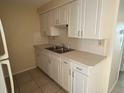 Functional kitchen features white cabinets, double sink, and ample counter space at 4217 Terrapin Pl # 4217, New Port Richey, FL 34652