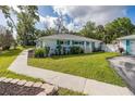 Beautiful single-story home with well-kept lawn, a tidy garden bed, and a paved walkway along the side at 4573 Ontario Dr, New Port Richey, FL 34652