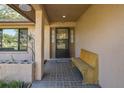 Inviting front entrance with a tiled porch, bench, and well-lit doorway at 512 Winding Willow Dr, Palm Harbor, FL 34683