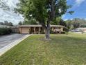 Charming single-story home with a well-maintained lawn and mature landscaping in a peaceful neighborhood at 5406 Dartmouth Rd, New Port Richey, FL 34652