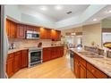 Well-equipped kitchen boasts stainless steel appliances, granite countertops, and warm wood cabinetry at 5411 Wellfield Rd, New Port Richey, FL 34655