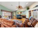 Inviting living room with vaulted ceilings, fireplace, and a comfortable seating arrangement at 5411 Wellfield Rd, New Port Richey, FL 34655