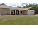 Charming single-story home with brick facade, well-kept lawn, and an attached single-car garage at 6516 Hillview Rd, Spring Hill, FL 34606