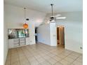 Open living room with tile flooring, vaulted ceilings, and a ceiling fan at 6527 Spring Flower Dr # 24, New Port Richey, FL 34653