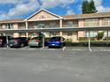 Exterior shot of building showing assigned resident parking spots under covered carports at 6527 Spring Flower Dr # 24, New Port Richey, FL 34653