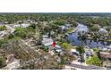 Aerial view of a residential property with waterfront access, a private dock, and a sparkling pool at 6552 River Rd, New Port Richey, FL 34652
