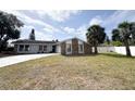 Charming single-story home featuring a stone facade, well-maintained lawn, and a paved driveway at 7026 Whitethorn Ct, Port Richey, FL 34668