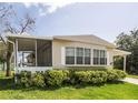Inviting mobile home featuring a screened porch and covered parking area at 846 Oakwood Dr, Tarpon Springs, FL 34689