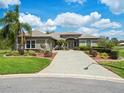 Attractive single-story home with a paver driveway, lush landscaping, and a tiled roof for a stylish curb appeal at 9032 Cypress Glen Ct, Weeki Wachee, FL 34613