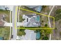 Aerial view of a property with a screened pool, solar panels, and a well-maintained backyard at 9301 Tournament Dr, Hudson, FL 34667