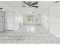 Bright, open living room with tile floors and a ceiling fan at 9316 Whitman Ln, Port Richey, FL 34668