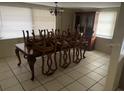 Dining room features a table with chairs, a chandelier and a display cabinet at 11515 Meredith Ln, Port Richey, FL 34668
