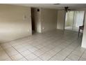 The living room features tile floors, neutral walls, and sliding glass doors at 11515 Meredith Ln, Port Richey, FL 34668