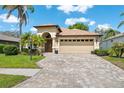 Charming single-story home with lush landscaping, paver driveway, and a two-car garage at 11631 Wayside Willow Ct, Hudson, FL 34667