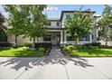 Charming two-story home with landscaped yard and a cozy front porch with rocking chairs at 12272 Rangeland Blvd, Odessa, FL 33556