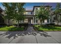 Charming two-story home with landscaped yard and a cozy front porch with rocking chairs at 12272 Rangeland Blvd, Odessa, FL 33556