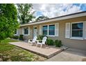 Inviting single-story home with a cozy front porch seating area at 12478 Prescott St, Spring Hill, FL 34609