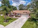Beautiful single-Gathering home with a well-maintained lawn, mature trees, and a two-car garage at 1280 Thornton Ct, Spring Hill, FL 34608