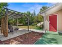 Relaxing backyard featuring a pergola, hammock, comfortable seating, and vibrant greenery, perfect for outdoor enjoyment at 1309 45Th S St, St Petersburg, FL 33711