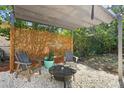 Inviting backyard patio with stone ground, a fire pit, pergola, perfect for outdoor relaxation and entertaining at 1309 45Th S St, St Petersburg, FL 33711