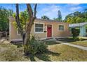 Charming single story home with a red front door, a well-manicured lawn, and mature landscaping at 1309 45Th S St, St Petersburg, FL 33711
