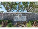 Stone sign with the name of the community 'The Bentley at Cobb's Landing' address 3320 at 3260 Haviland Ct # 201, Palm Harbor, FL 34684