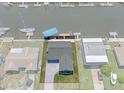 Aerial view of a home along a canal, showcasing its waterfront location and surrounding properties at 3362 Minnow Creek Dr, Hernando Beach, FL 34607