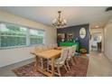 Inviting dining room featuring a wooden table, chandelier, and a decorative green sideboard at 37623 Florida Ave, Dade City, FL 33525