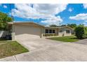 Spacious home with an attached garage, long driveway and attractive landscaping enhancing its curb appeal at 37623 Florida Ave, Dade City, FL 33525