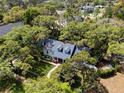 Aerial view of a charming home surrounded by lush trees and greenery at 417 Inness Dr, Tarpon Springs, FL 34689