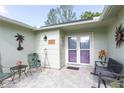 Inviting covered front porch with chairs, perfect for relaxing and enjoying the outdoors at 4647 Gazebo Ct, New Port Richey, FL 34655