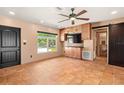 Open living room featuring a ceiling fan, tile floors, built-in cabinets, and a view of the neighborhood at 7230 17Th N Ln, St Petersburg, FL 33702