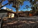 Exterior view of a quaint home with stone accents and a well-maintained front yard at 8930 Phelps Rd, Hudson, FL 34667