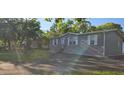 Inviting single-story home with manicured lawn and an asphalt driveway leading to the front at 9625 Pat St, Hudson, FL 34669