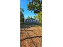 Single-story home surrounded by mature trees, features a well-maintained exterior at 9625 Pat St, Hudson, FL 34669