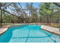 Sparkling in-ground pool with a screened enclosure offers the perfect spot for relaxation and recreation at 10531 Lakeview Dr, New Port Richey, FL 34654