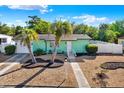 Charming single-story home with a well-manicured, low-maintenance lawn and mature palm trees at 1054 Embassy Ave, Spring Hill, FL 34606