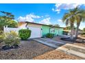 Charming single-story home featuring an attached garage, driveway, and palm tree landscaping at 1054 Embassy Ave, Spring Hill, FL 34606