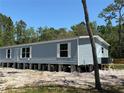 Side view of a home, showing the light blue siding and white trim at 11444 Lake Dr, New Port Richey, FL 34654