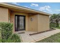 Inviting front entrance with a black door, creating a warm and welcoming first impression at 12004 Valley Falls Loop, Spring Hill, FL 34609