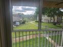 View from the screened-in patio of a grassy outdoor space at 12119 Sunny Glen Ln # G2, Hudson, FL 34669
