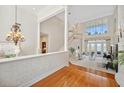 Bright and spacious living room with soaring ceilings, hardwood floors, staircase and water views at 1473 Sail Harbor Cir, Tarpon Springs, FL 34689